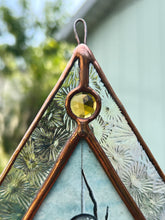 Load image into Gallery viewer, Close up of yellow gem. Spider with miniature landscape in body above pressed daisy flower and fern painted with gouache on paper set between glass. Iridescent floral textured glass border and yellow gem.
